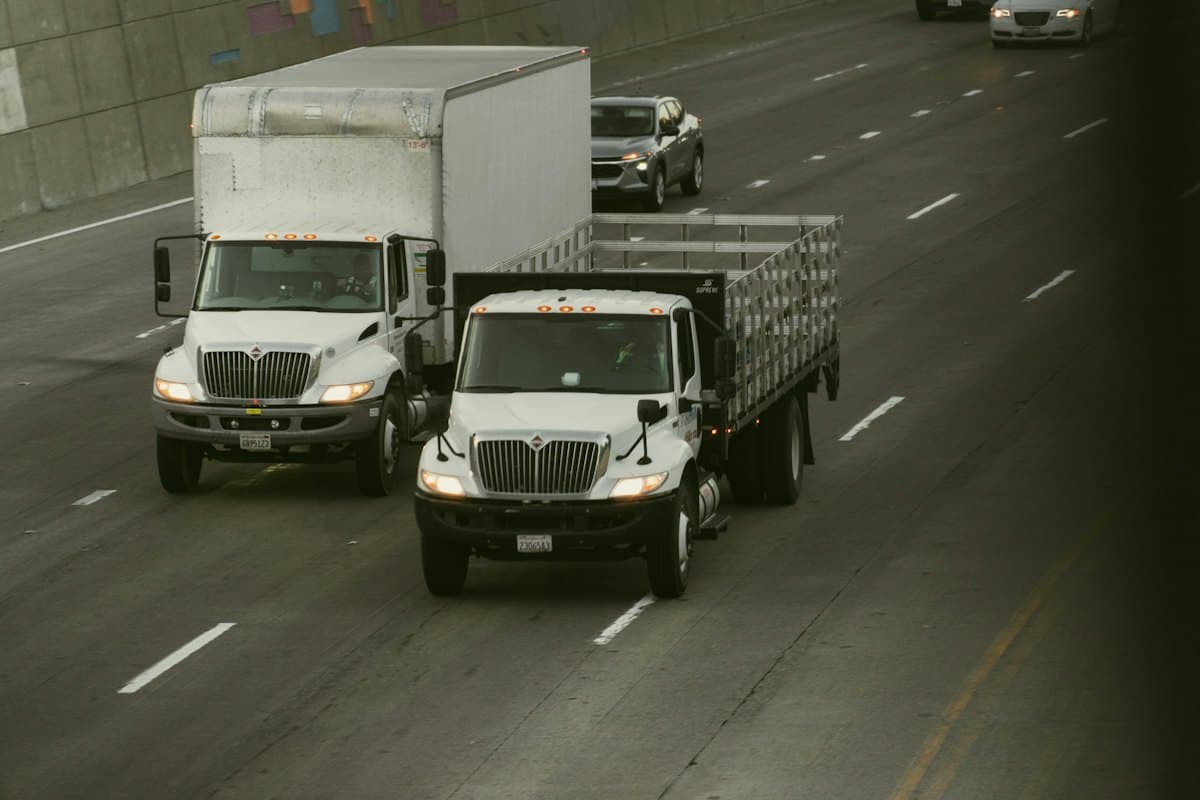 White box lorries travelling along a highway